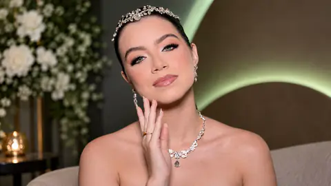 Noiva com tiara de cristais e colar de gotas, com maquiagem em tons neutros